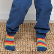 Boy in rainbow rocket socks