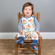 Baby in rainbow apple dungarees