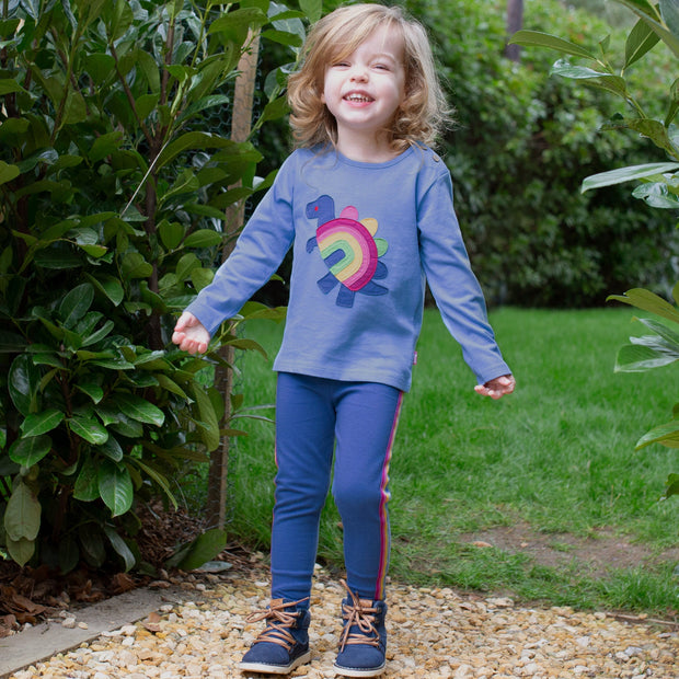 Girl in rainbow-saurus t-shirt