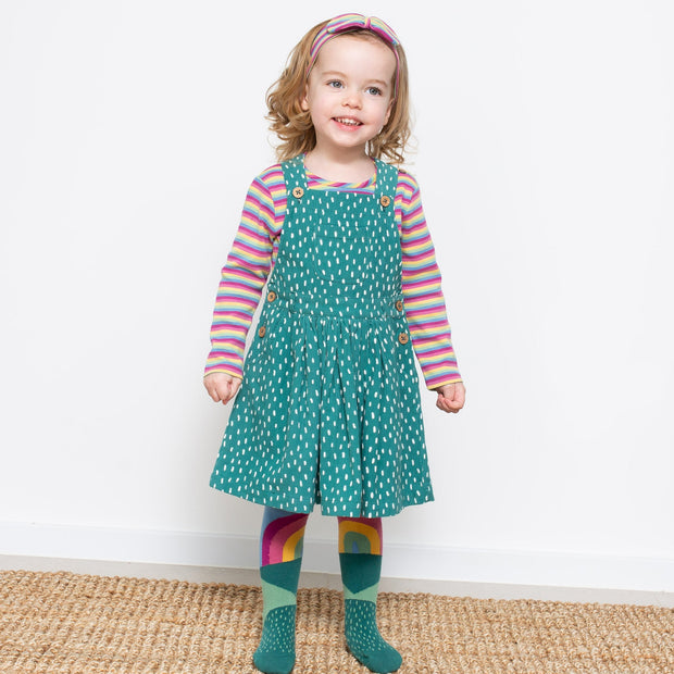 Girl in speckle pinafore