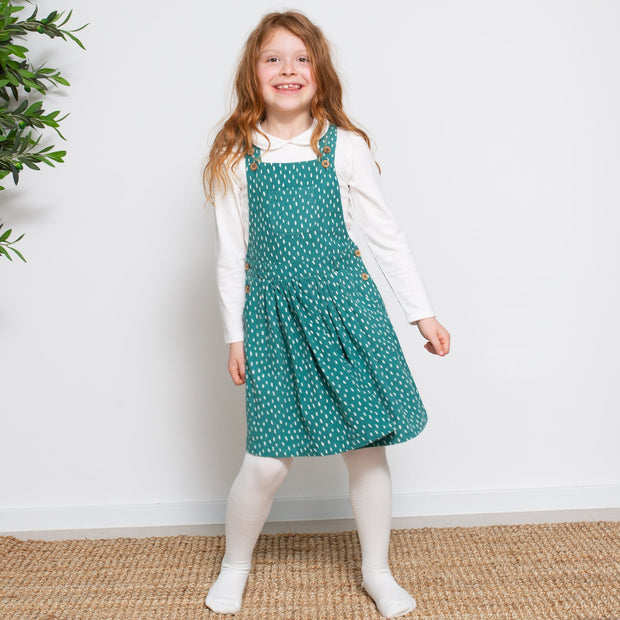 Girl in speckle pinafore