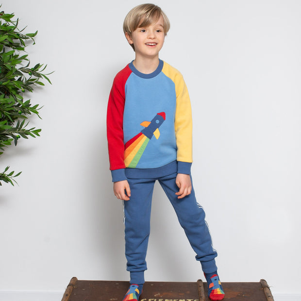 Boy in rainbow rocket sweatshirt