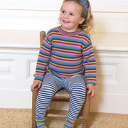Girl in rainbow stripe jumper